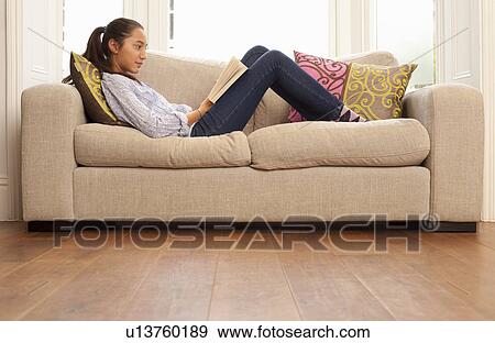teenage girl reading on sofa View Large Photo Image Stock Photo - teenage girl reading on sofa. Fotosearch