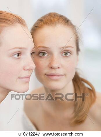 Teenage girl standing near mirror View Large Photo Image Stock Photo - Teenage girl standing near mirror. Fotosearch