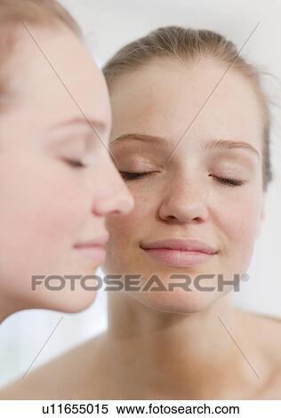 Stock Photography - Teenage girl standing near mirror. Fotosearch