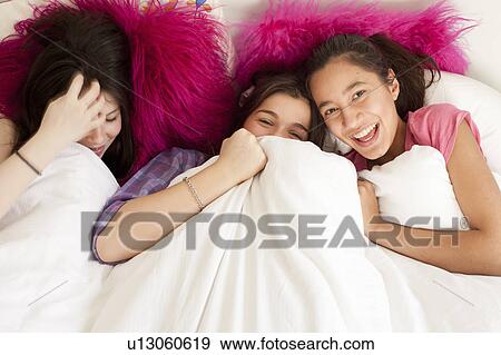 teenage girls having fun in bed View Large Photo Image Stock Photo - teenage girls having fun in bed . Fotosearch