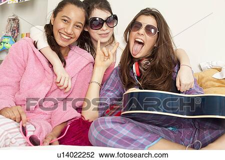 teenage girls laughing and playing music View Large Photo Image Stock Image - teenage girls laughing and playing music. Fotosearch