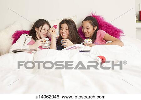 teenage girls laughing and playing music View Large Photo Image Stock Photograph - teenage girls laughing and playing music. Fotosearch