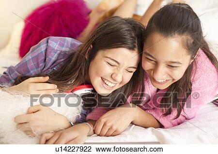 teenage girls laughing looking at laptop View Large Photo Image Stock Image - teenage girls laughing looking at laptop. Fotosearch