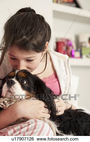teenage girls playing with dog at home View Large Photo Image Stock Photograph - teenage girls playing with dog at home . Fotosearch