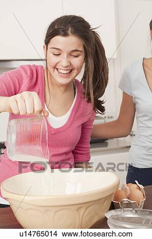 teenage girls preparing food in kitchen View Large Photo Image Picture - teenage girls preparing food in kitchen. Fotosearch