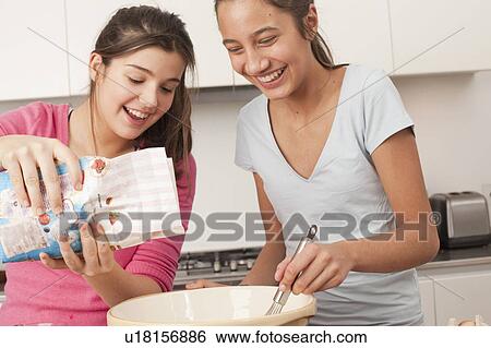 teenage girls preparing food in kitchen View Large Photo Image Stock Photograph - teenage girls preparing food in kitchen. Fotosearch