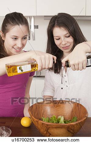 teenage girls preparing salad in kitchen View Large Photo Image Stock Image - teenage girls preparing salad in kitchen. Fotosearch