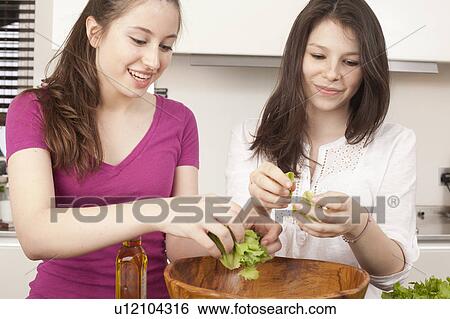 teenage girls preparing salad in kitchen View Large Photo Image Stock Photograph - teenage girls preparing salad in kitchen. Fotosearch