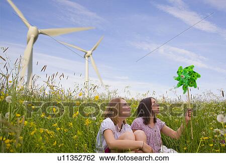 Teenage girls with wind turbines View Large Photo Image Stock Image - Teenage girls with wind turbines. Fotosearch