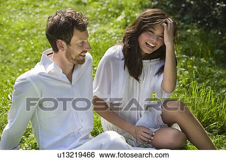 Stock Photograph - The couple having fun in the park. Fotosearch