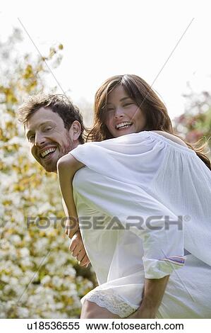 Stock Photography - The couple having fun in the park. Fotosearch