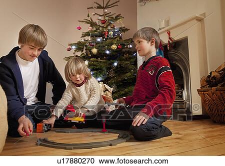 Three boys playing with a train set View Large Photo Image Stock Image - Three boys playing with a train set. Fotosearch