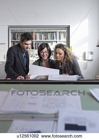 Three colleagues working together View Large Photo Image Stock Image - Three colleagues working together. Fotosearch