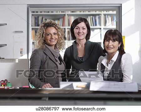 Three female colleagues in Office View Large Photo Image Stock Photo - Three female colleagues in Office. Fotosearch