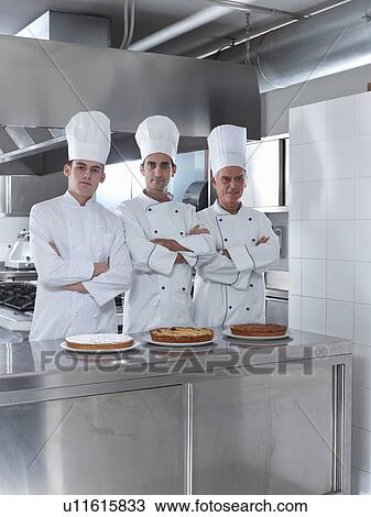 Three generations of chefs in restaurant kitchen with home made cake View Large Photo Image Stock Image - Three generations of chefs in restaurant kitchen with home made cake. Fotosearch