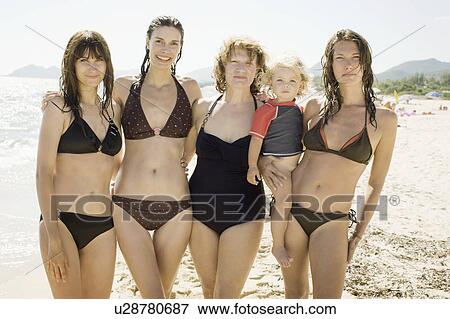 Stock Photo - Three generations of women on beach. Fotosearch