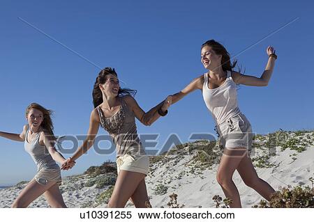 Three girls running down hill View Large Photo Image Stock Photography - Three girls running down hill. Fotosearch