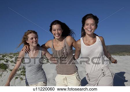 Three girls smiling into camera View Large Photo Image Stock Image - Three girls smiling into camera. Fotosearch