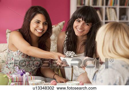 Three women celebrating with presents View Large Photo Image Stock Image - Three women celebrating with presents. Fotosearch
