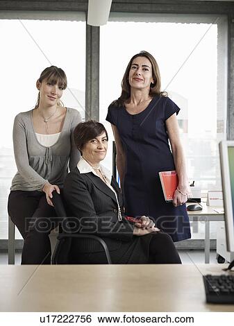 Three women in a group meeting View Large Photo Image Stock Photograph - Three women in a group meeting. Fotosearch