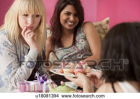 Three young women having a tea party View Large Photo Image Picture - Three young women having a tea party. Fotosearch