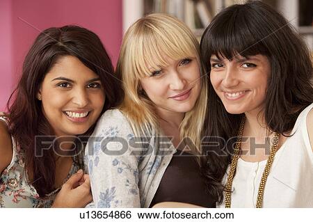Three young women looking to camera View Large Photo Image Stock Photograph - Three young women looking to camera. Fotosearch