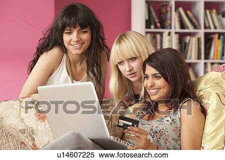 Three young women shopping on computer View Large Photo Image Stock Photography - Three young women shopping on computer. Fotosearch