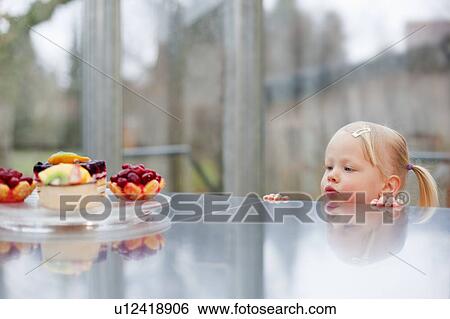 Toddler girl admiring fruit cakes View Large Photo Image Stock Photograph - Toddler girl admiring fruit cakes. Fotosearch