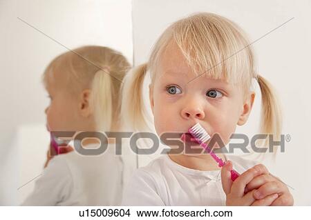 Toddler girl brushing her teeth View Large Photo Image Picture - Toddler girl brushing her teeth. Fotosearch