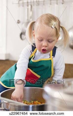 Toddler girl cooking in kitchen View Large Photo Image Picture - Toddler girl cooking in kitchen. Fotosearch