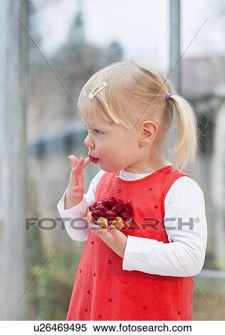 Toddler girl eating fruit cake View Large Photo Image Stock Photography - Toddler girl eating fruit cake. Fotosearch