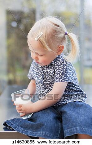 Toddler girl holding glass of milk View Large Photo Image Stock Photography - Toddler girl holding glass of milk. Fotosearch