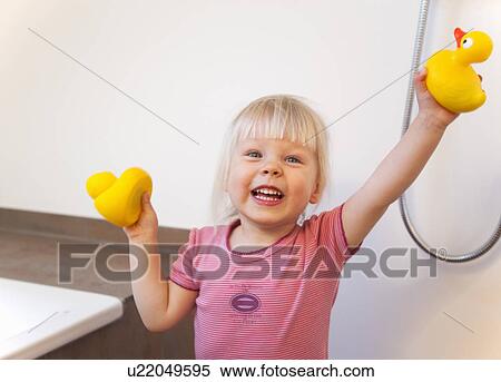 Toddler girl playing with rubber ducks View Large Photo Image Stock Photography - Toddler girl playing with rubber ducks. Fotosearch
