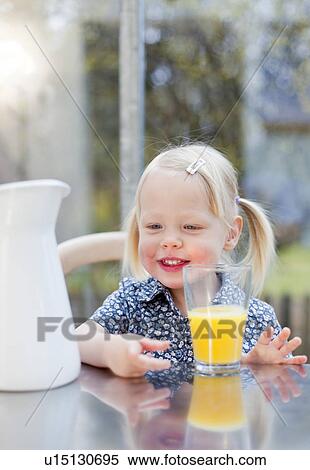 Stock Photography - Toddler girl with glass of juice. Fotosearch
