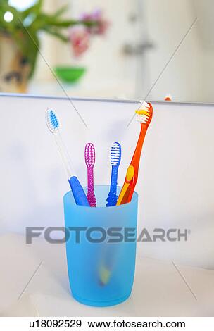 Toothbrushes in cup View Large Photo Image Stock Photo - Toothbrushes in cup. Fotosearch