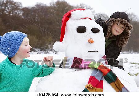 Two boys and a snowman View Large Photo Image Picture - Two boys and a snowman. Fotosearch