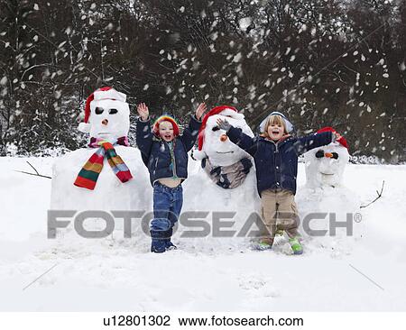 Two boys and their snowmen View Large Photo Image Stock Image - Two boys and their snowmen. Fotosearch