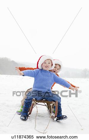 Stock Photography - Two boys on a sledge. Fotosearch