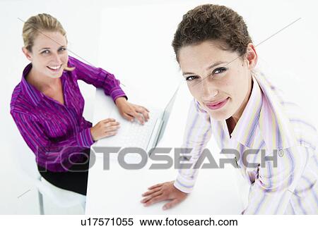 Two confident business women look up View Large Photo Image Stock Photography - Two confident business women look up. Fotosearch