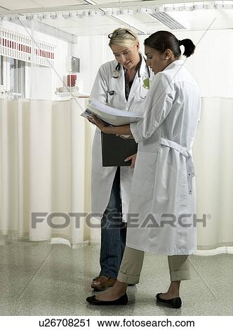 Stock Image - Two doctors discussing. Fotosearch