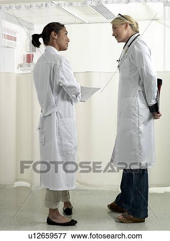 Stock Photo - Two doctors discussing. Fotosearch