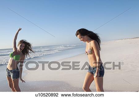 Stock Image - Two girls on the beach. Fotosearch