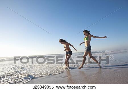 Two girls running on beach View Large Photo Image Stock Photography - Two girls running on beach. Fotosearch