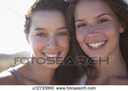 Two girls smiling in camera View Large Photo Image Stock Image - Two girls smiling in camera. Fotosearch
