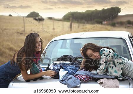 Stock Image - Two girls waiting. Fotosearch