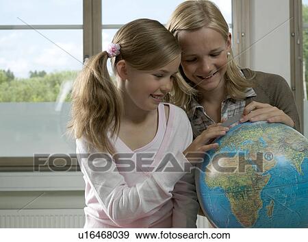 Two girls with earth globe View Large Photo Image Stock Photo - Two girls with earth globe. Fotosearch