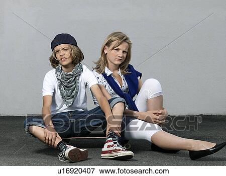 Two kids on a skateboard View Large Photo Image Stock Photo - Two kids on a skateboard. Fotosearch