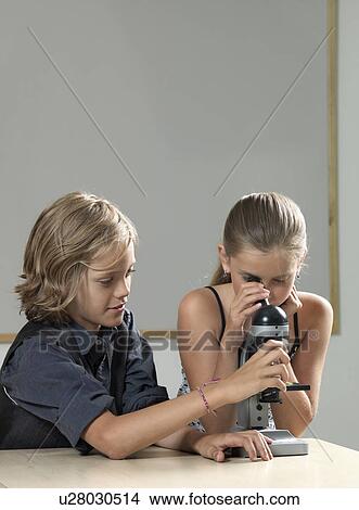 Two kids using microscope View Large Photo Image Picture - Two kids using microscope. Fotosearch