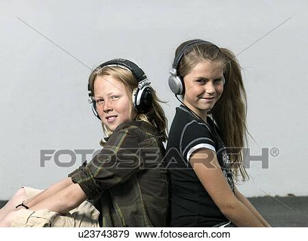 Stock Photo - Two kids with head phones. Fotosearch