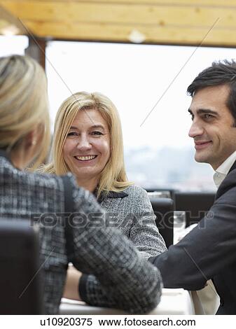 Two Women and one man in a buiness meeting View Large Photo Image Stock Photography - Two Women and one man in a buiness meeting. Fotosearch